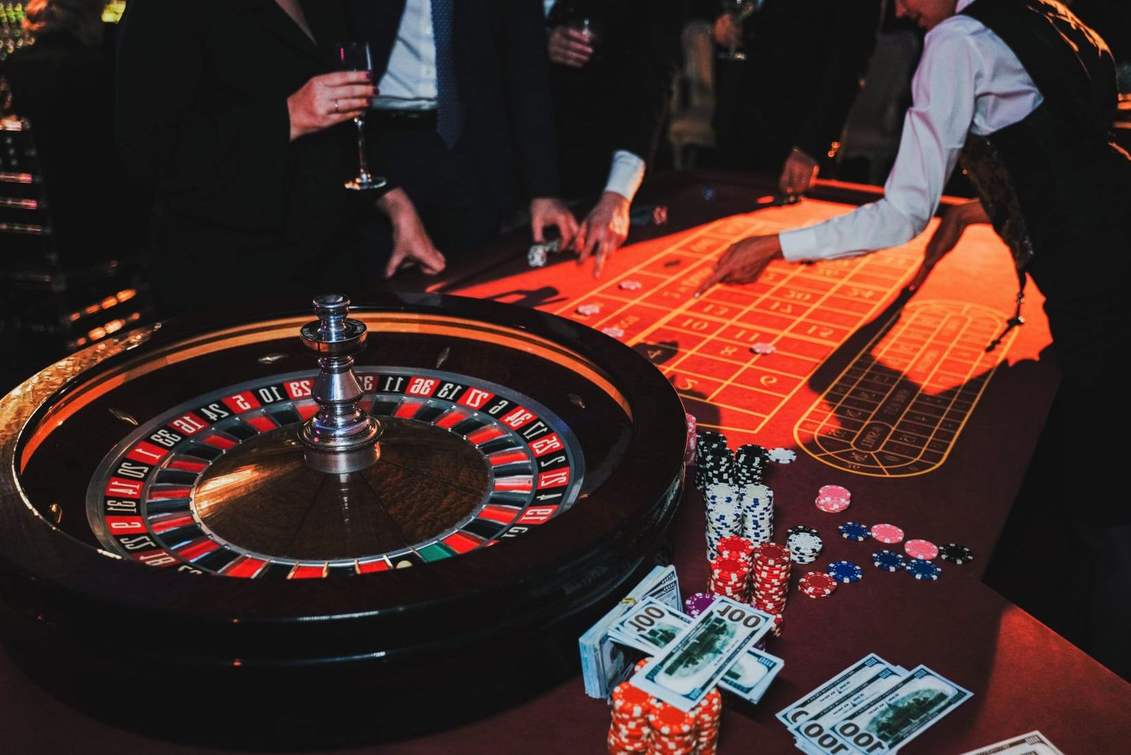 Casino-themed event room prepared with a roulette-inspired wheel, chips and cards