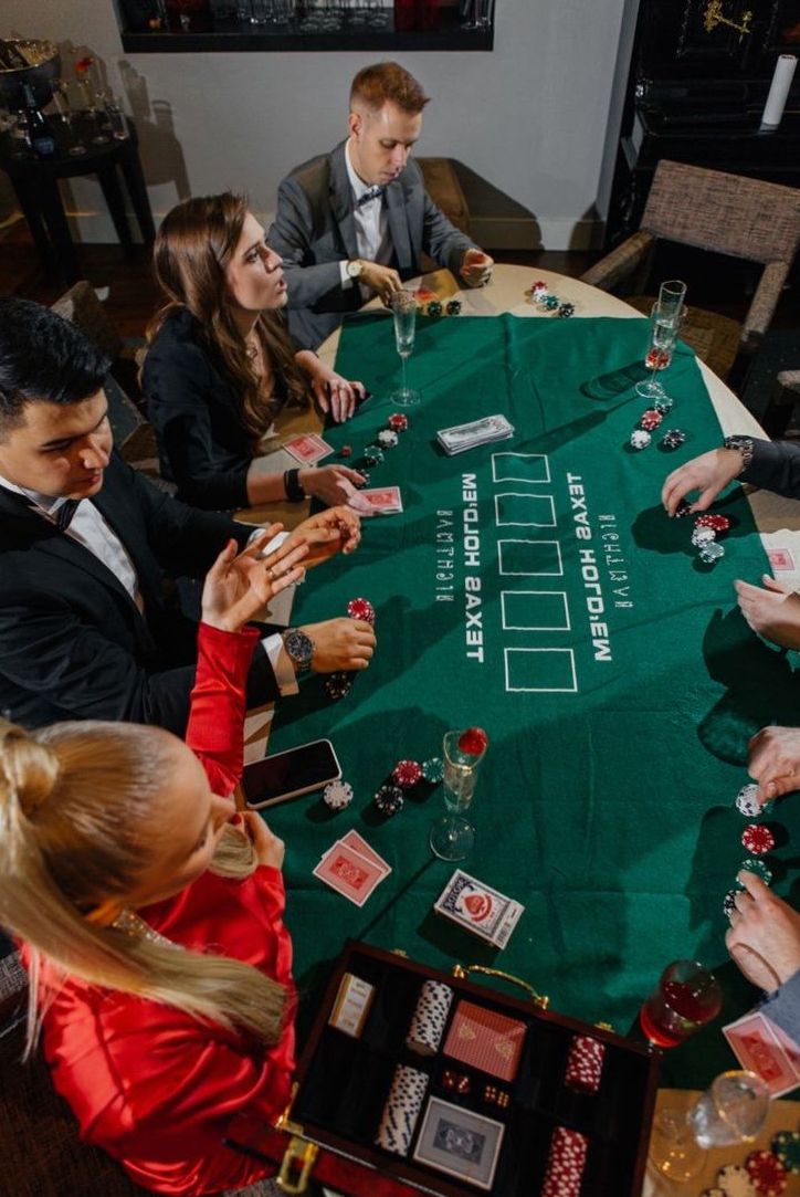 Casino-themed event space arranged with multiple hosted entertainment stations