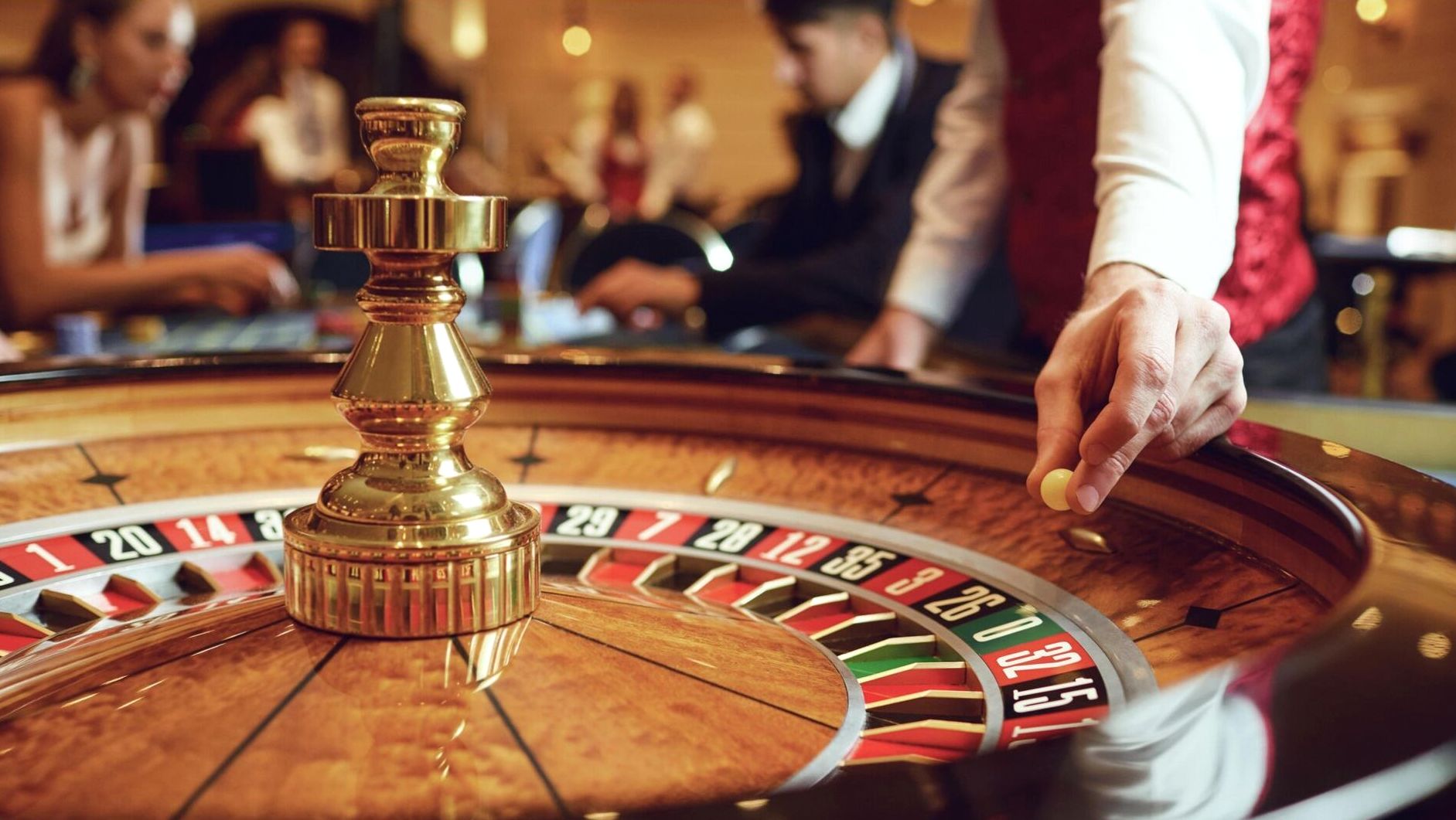Event venue dressed for a casino-themed evening with warm pendant lighting